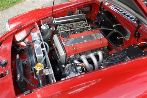 Cast Alloy MGC Cylinder Head comes fully built with solid single piece valves, uprated springs and retaining caps and a clean up. . Mgb engine swap kit